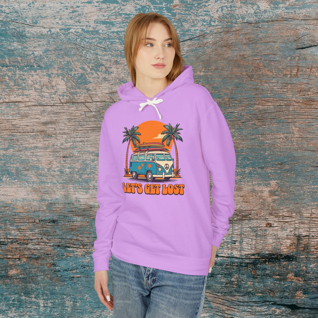 Person wearing a purple hoodie with a graphic design of a van and palm trees, standing against a wooden background.