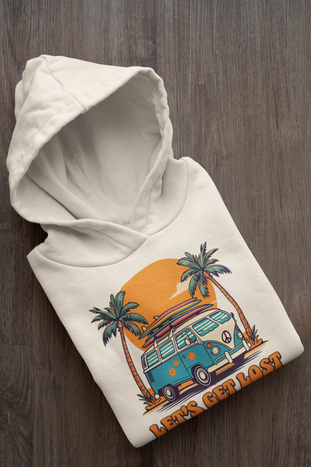 White hoodie with a graphic design of a van and palm trees on a wooden surface