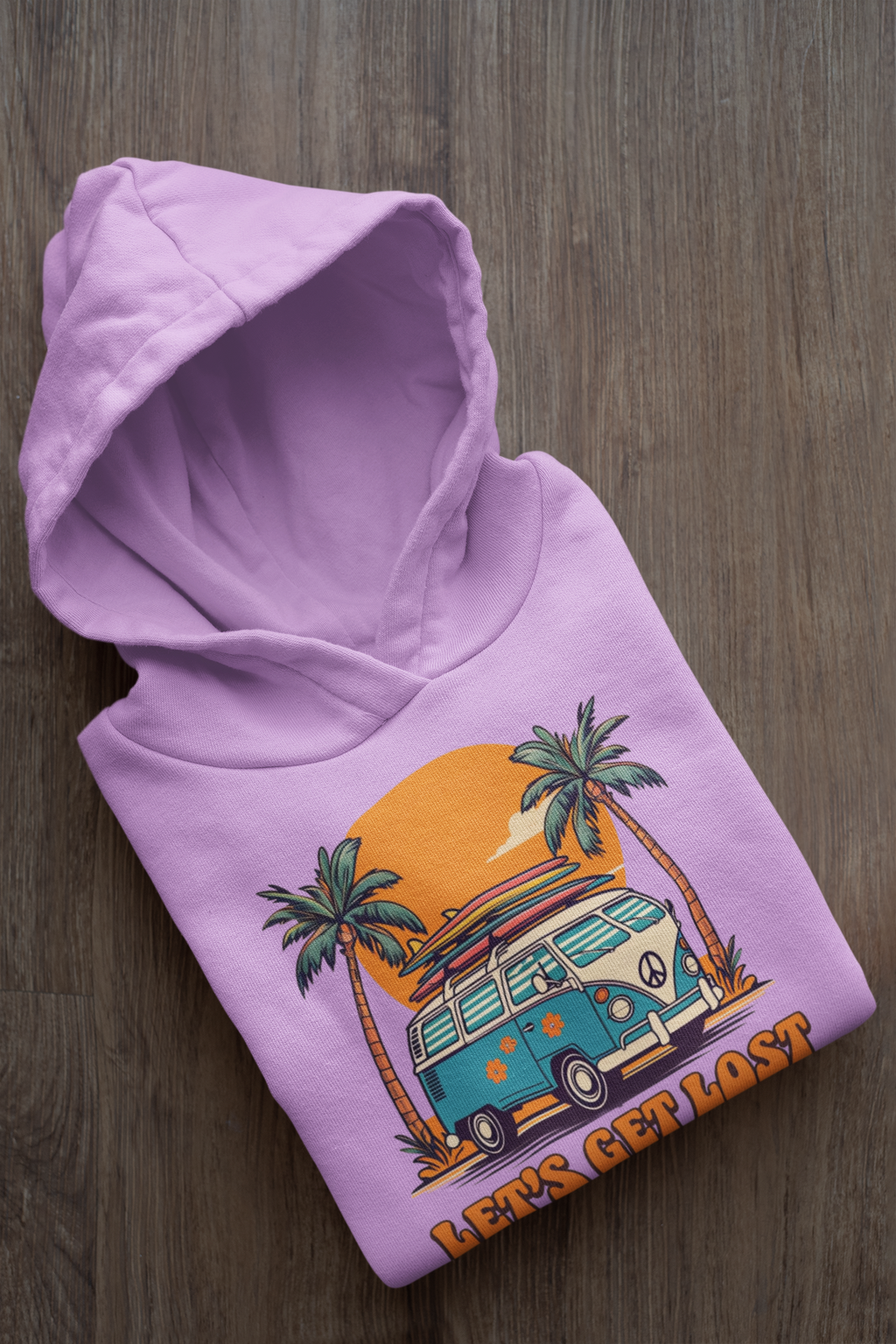 Purple hoodie with a graphic of a van and palm trees on a wooden surface