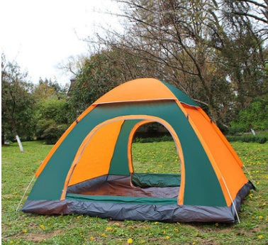 Orange and green tent set up in a grassy area with trees in the background