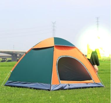 Colorful camping tent on grass with a clear sky