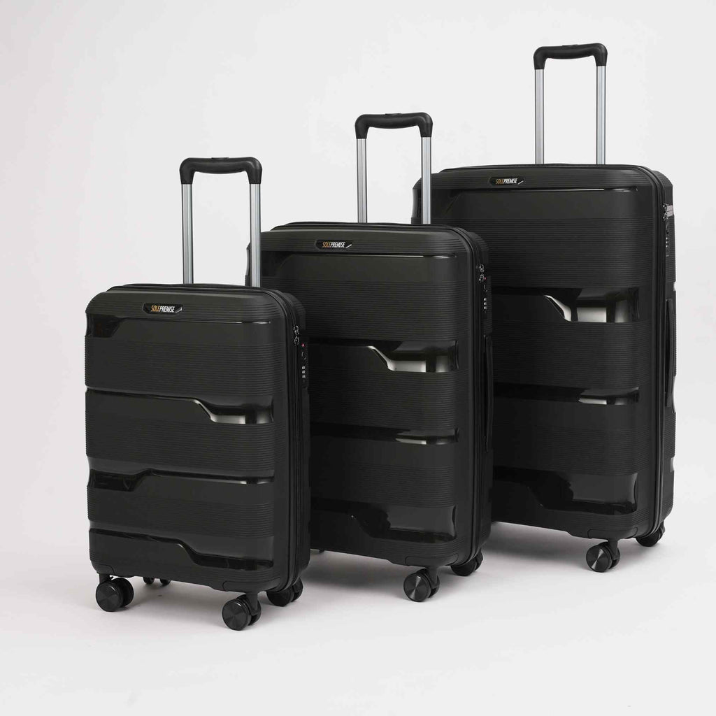 Three black suitcases of different sizes on a white background