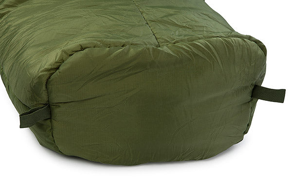 Green sleeping bag on a white background