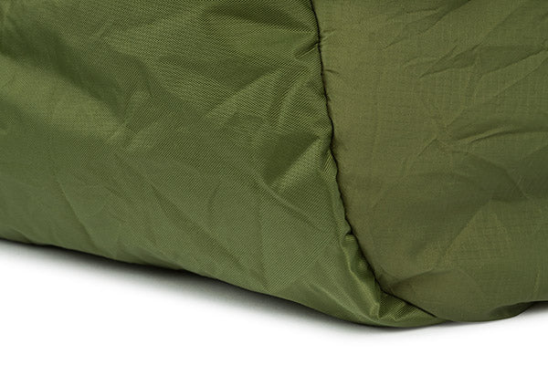 Close-up of a green quilted fabric on a white background