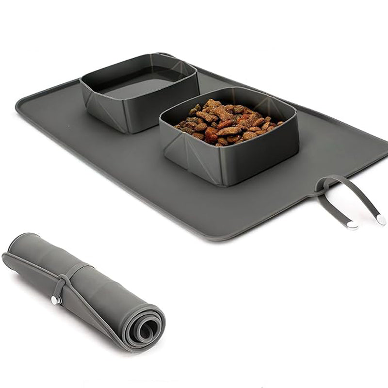 Gray pet dining mat with two bowls and a rolled-up mat on a white background