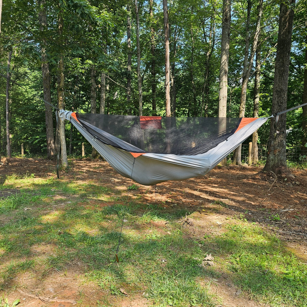 Hammock hanging between trees in a forest setting