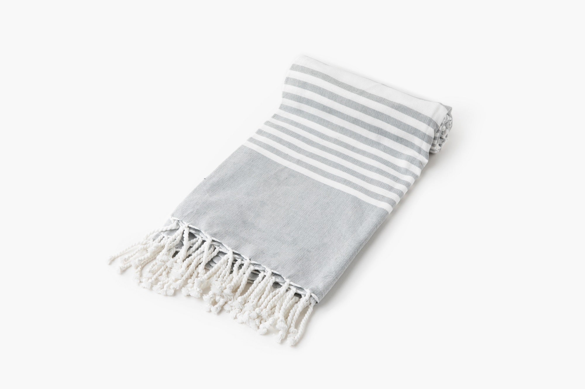 Gray and white striped towel with fringes on a white background